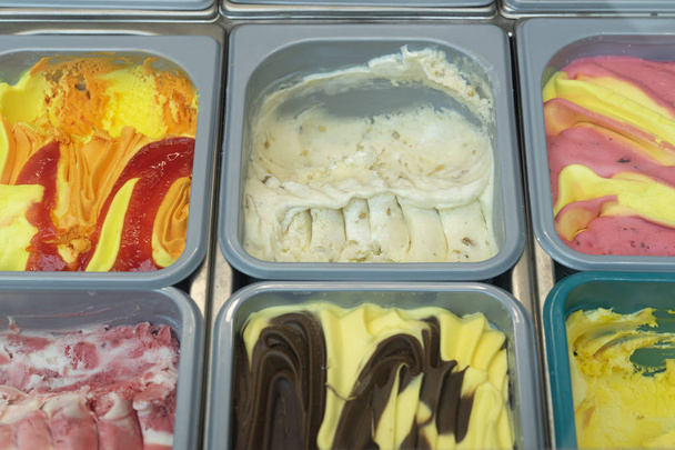 Ice cream in a box. Showcase with colorful fruit ice cream - Fotó, kép
