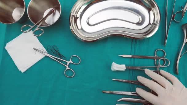 Chirurg pracujący w sali operacyjnej, ręce z rękawicami trzymania nożyczek z szwem i torundas, obraz koncepcyjny, composicon poziome - Materiał filmowy, wideo