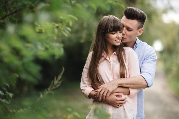 Loving young couple kissing and hugging in outdoors. Love and te - Фото, зображення