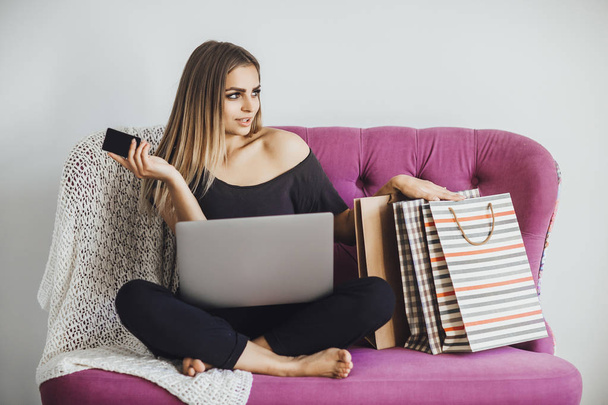 young beautiful woman holding credit card in hand and online shopping for laptop  - Φωτογραφία, εικόνα