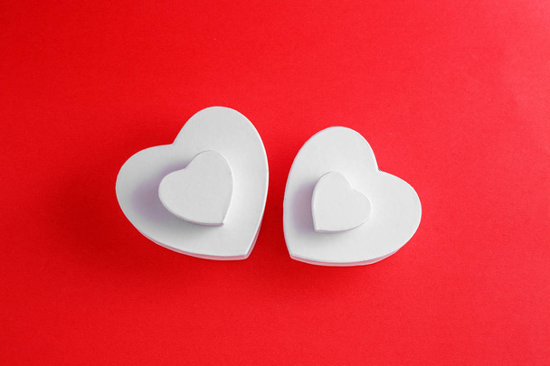 Handmade cardboard hearts on a red background. The concept is suitable for love stories and for Valentine's Day - Foto, Imagem