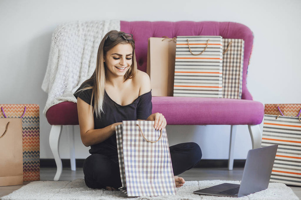young beautiful woman shopping through Internet at home - Фото, изображение