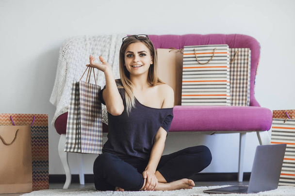young beautiful woman after shopping through Internet at home - Photo, image