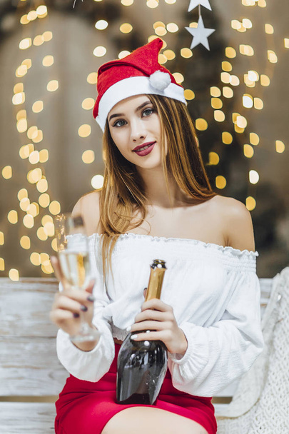 woman drinking champagne from glass against new year background - Фото, зображення