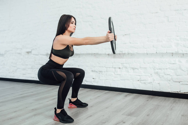 brunette woman exercising fitness body building exercises in studio - Fotó, kép