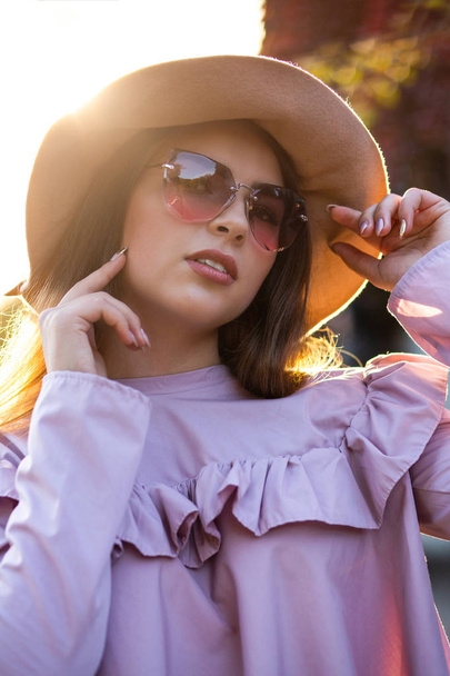 Modieuze brunette model dragen van trendy hoed en zonnebril, po - Foto, afbeelding