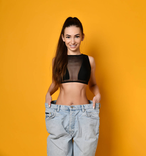 beautiful young woman with big jeans - Fotoğraf, Görsel