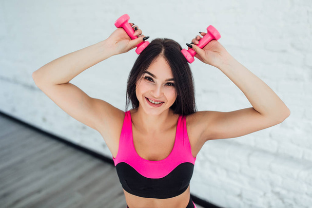 Young woman in pink sportswear on white background - Foto, afbeelding