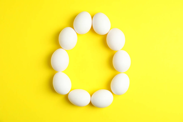 Flat lay composition with chicken eggs on color  background, spa - Foto, Imagen