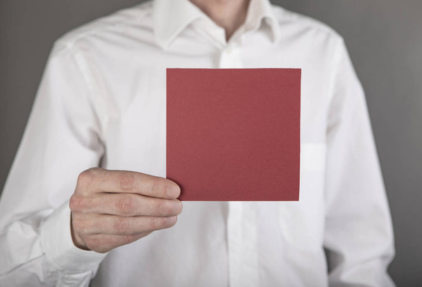 A man holding red note paper - Fotó, kép