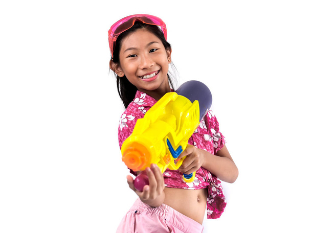 Young Asian girl with water gun on white background, Songkran Fe - Foto, immagini