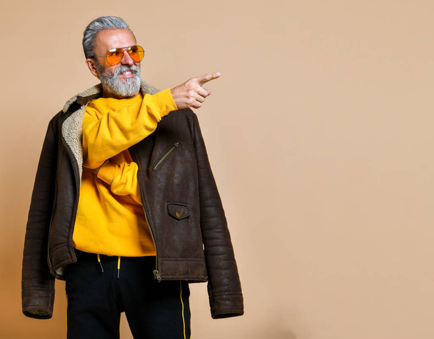 senior stylish rich man with a beard and mustache in a leather coat - Фото, зображення