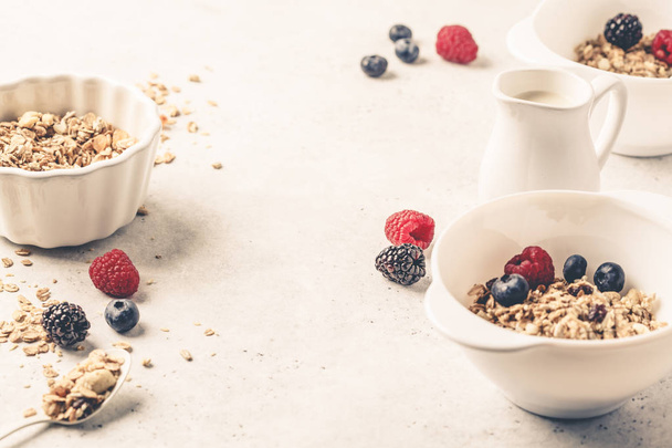 Breakfast food background. Granola with milk and berries on whit - Zdjęcie, obraz
