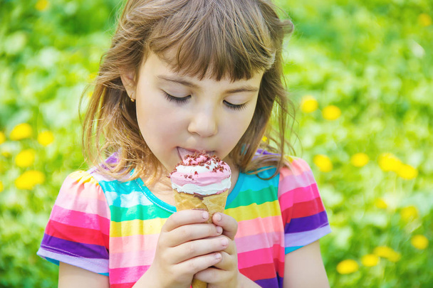 The child eats ice cream. Selective focus. - Photo, Image