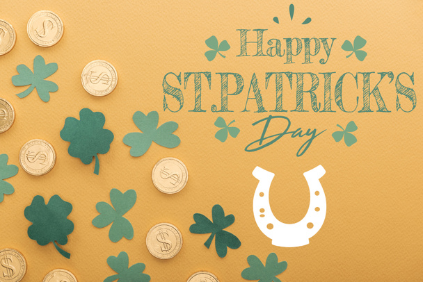 top view of golden coins with dollar signs near shamrocks and happy st patricks day lettering on orange background - Photo, Image