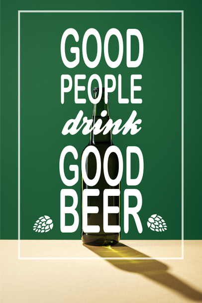 glass beer bottle with good people drink good beer lettering on green background - Fotó, kép