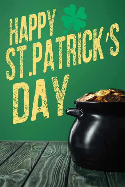 golden coins in pot  with happy st patricks day lettering on green background - 写真・画像