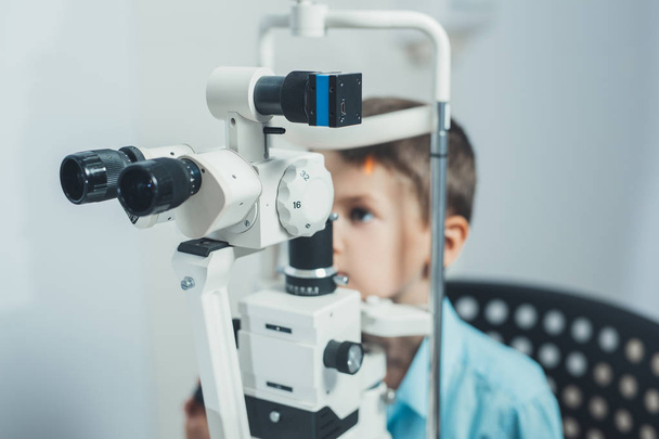 boy and equipment for vision tests in  hospital. - Фото, зображення
