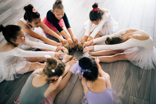 Group of fit children exercising ballet in studio together - Foto, immagini