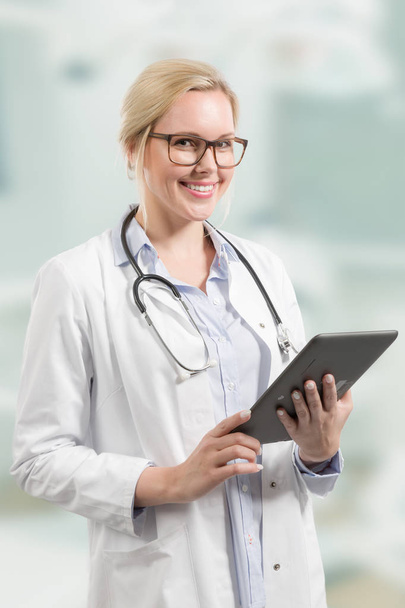 young and friendly female doctor with stethoscope and clipboard - Foto, immagini