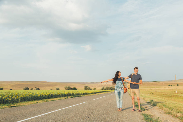 Girl and guy are on road. Concept - lifestyle. Copy space - Foto, Imagem