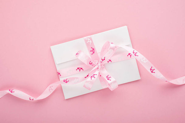Envelopes for congratulations lettering on a pastel pink background with a princess ribbon crown in pink hues. Horizontal - Photo, image