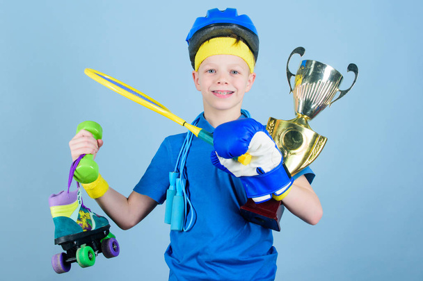 Succeed in everything. Athlete successful boy sport equipment jump rope boxing glove tennis racket roller skate and golden goblet. Success and award. Success in sport. Proud of achieved success - Fotografie, Obrázek
