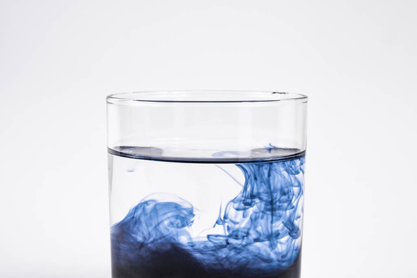 Water contamination concept. Dark substance dissolving with clea - 写真・画像