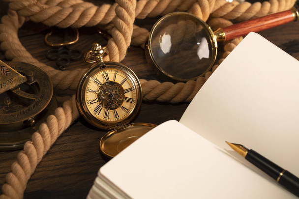Antique clock on the background of vintage notebook and pen. Bla - Foto, immagini