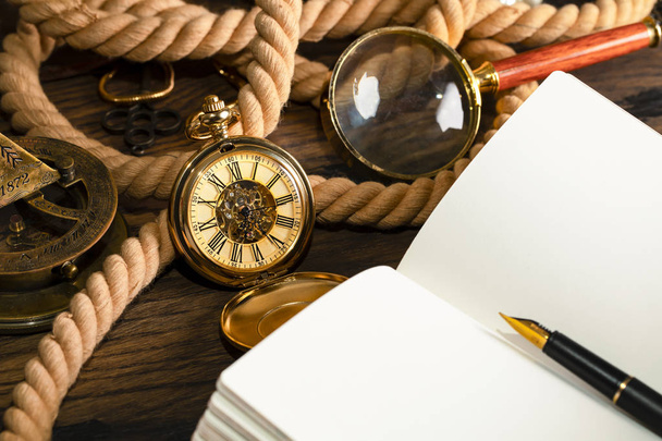 Antique clock on the background of vintage notebook and pen. Bla - Photo, image