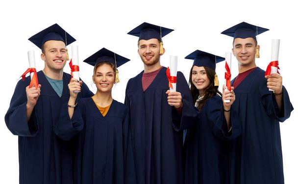 graduates in mortar boards with diplomas - Φωτογραφία, εικόνα