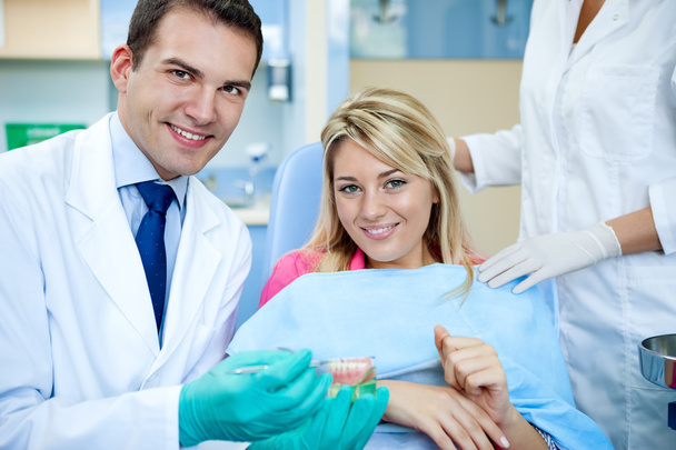 dentist explaining a female patient denture work - Φωτογραφία, εικόνα