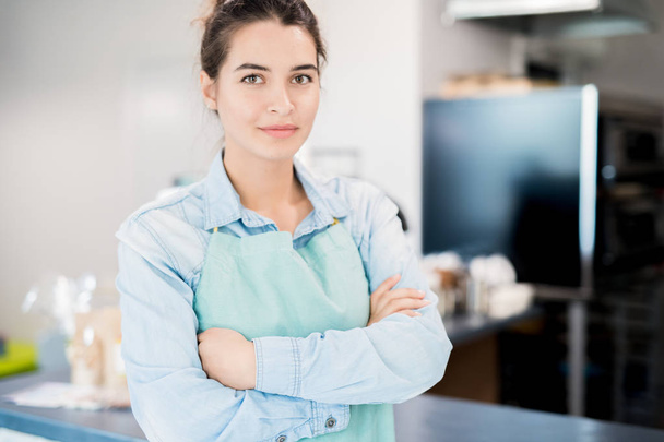 Waist up portrait of confident young woman standing with arms crossed in small shop and looking at camera, copy space - Photo, Image