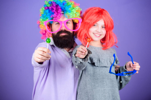 Easy simple ways be fun playful parent. How crazy is your father. Man bearded father and girl wear colorful wig while eat lollipop candy. Thing loving father do for children. Tribute to fun dad - Zdjęcie, obraz