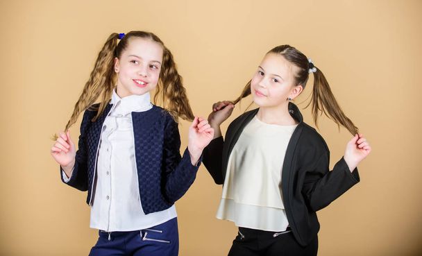 Hairstyle for female. Cheerful friends made same hairstyle for fun. We look like sisters. Best friends forever. Long hair hairstyle tips. Double ponytails hairstyle. Girls enjoy having long hair - Фото, изображение
