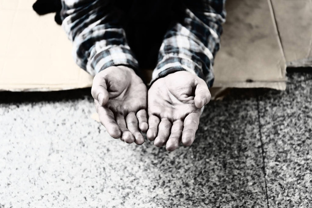Close-up hand of homeless man and wish money from people on walking street. - Photo, Image