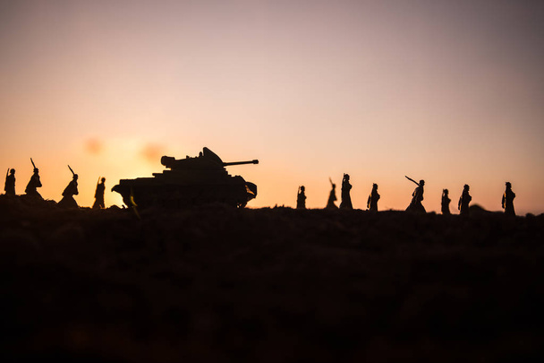 War Concept. Military silhouettes fighting scene on war fog sky background, World War Soldiers Silhouettes Below Cloudy Skyline at sunset. Attack scene. Armored vehicles. tank in action - Photo, Image