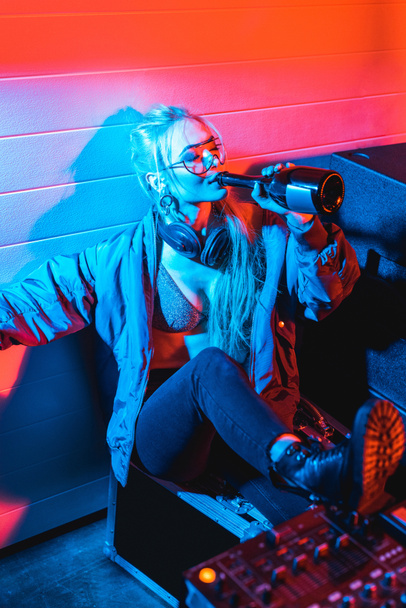 attractive dj woman drinking wine from bottle with closed eyes - Φωτογραφία, εικόνα