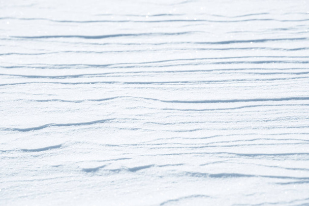 Φρέσκο χιόνι υφή φόντου. Χειμώνα φόντο με νιφάδες χιονιού και τα αναχώματα του χιονιού. Χιόνι εξογκώματα. - Φωτογραφία, εικόνα