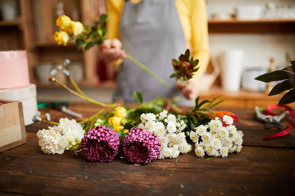 Closeup of assorted flowers lying on counter in flower shop, copy space - Photo, image