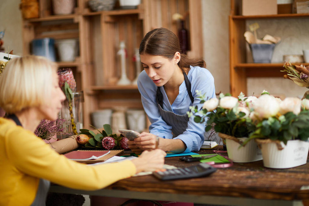 Portrait of two female business owners managing flower shop, copy space - Photo, image