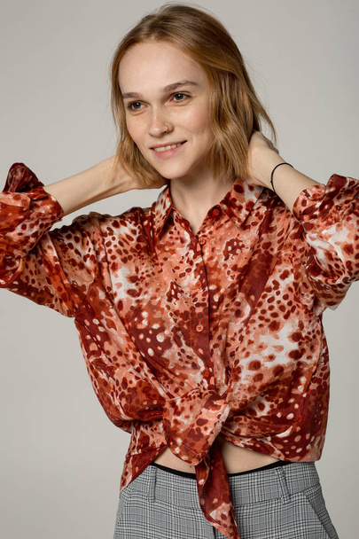 Portrai of beautiful blonde woman in red shirt - Fotoğraf, Görsel