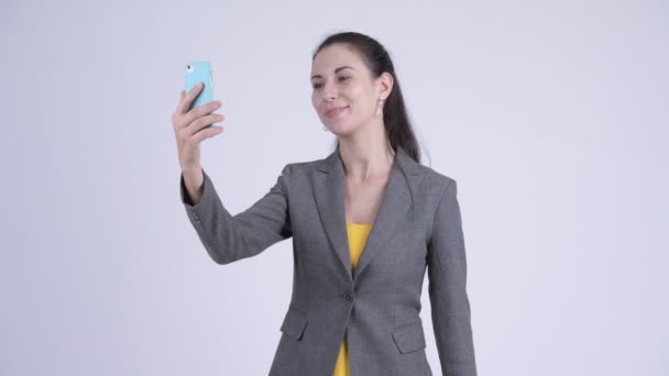 Happy young beautiful businesswoman video calling with phone - Filmmaterial, Video