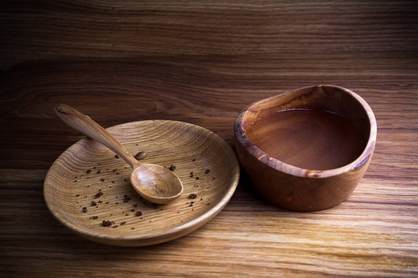 Fasting, Lent. Plate with spoon and cup of water on wooden background - Foto, afbeelding