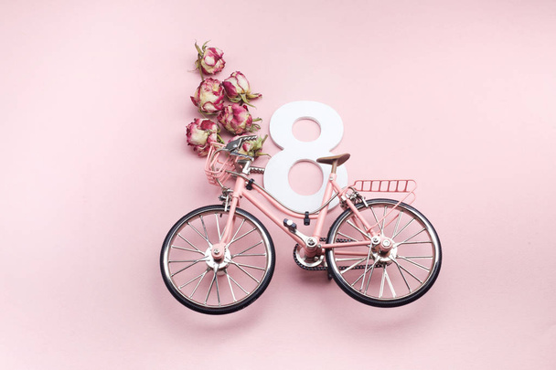 Happy International Womens Day celebrate on eight March. Number eight with pink bicycle on pink background - Φωτογραφία, εικόνα