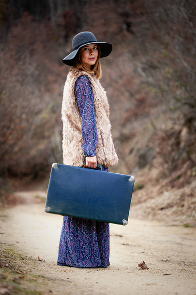 pretty girl with vintage case on a dirtroad - Photo, image