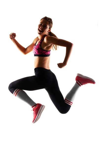 fit runner girl jumping - Φωτογραφία, εικόνα
