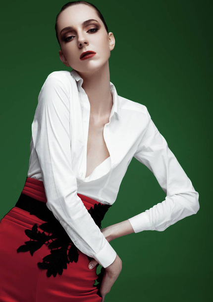 Fashion model wearing red pants and white shirt - 写真・画像