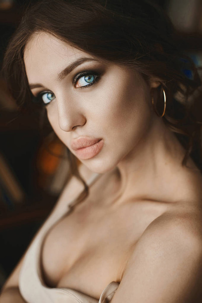Portrait of beautiful and sexy young brunette woman with blue-green eyes and big seductive lips - Fotó, kép