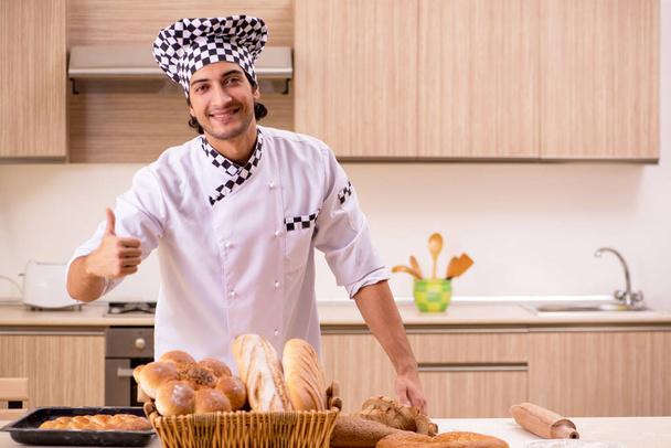 Young male baker working in kitchen  - Photo, Image